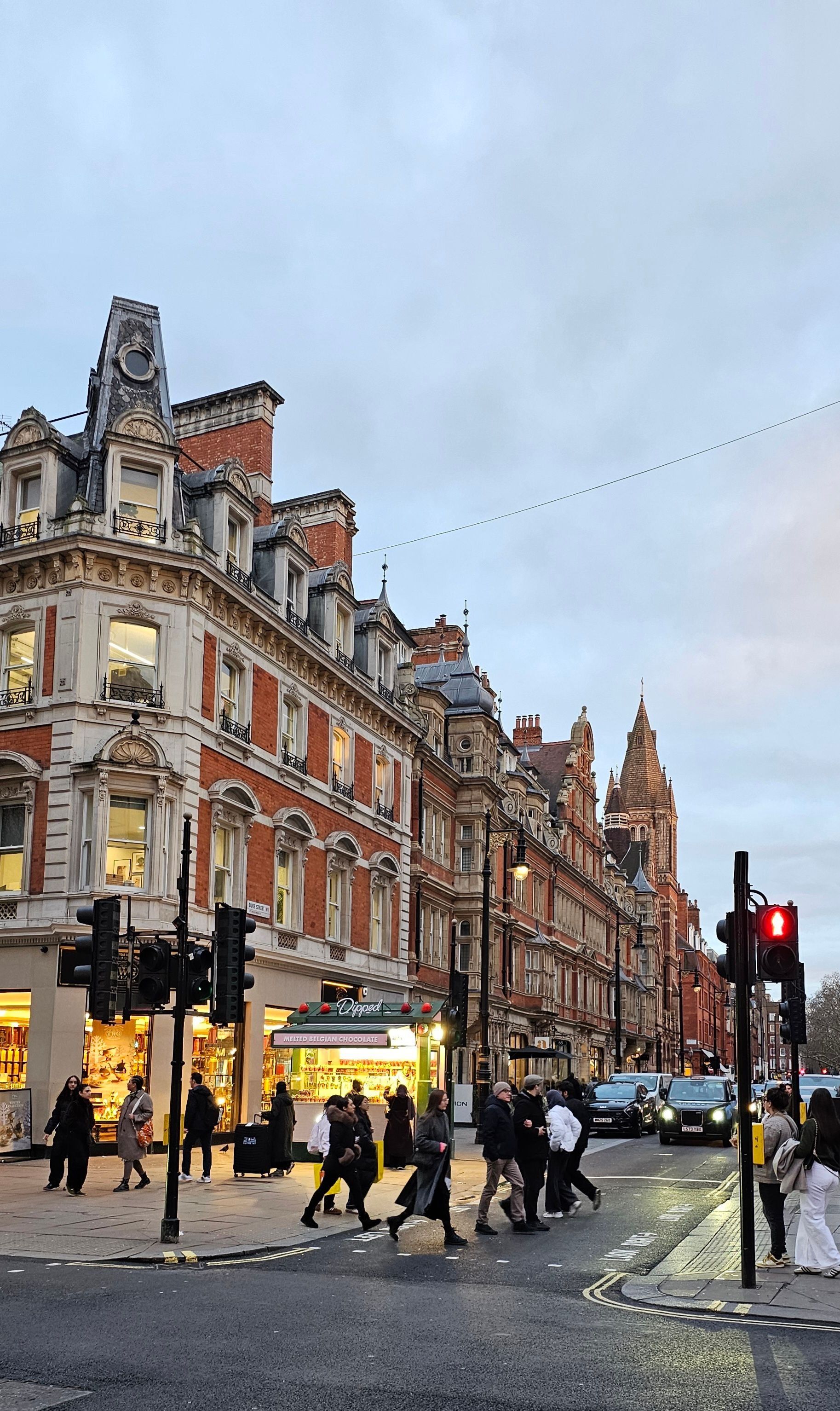 A London street of shops and lit windows at twilight